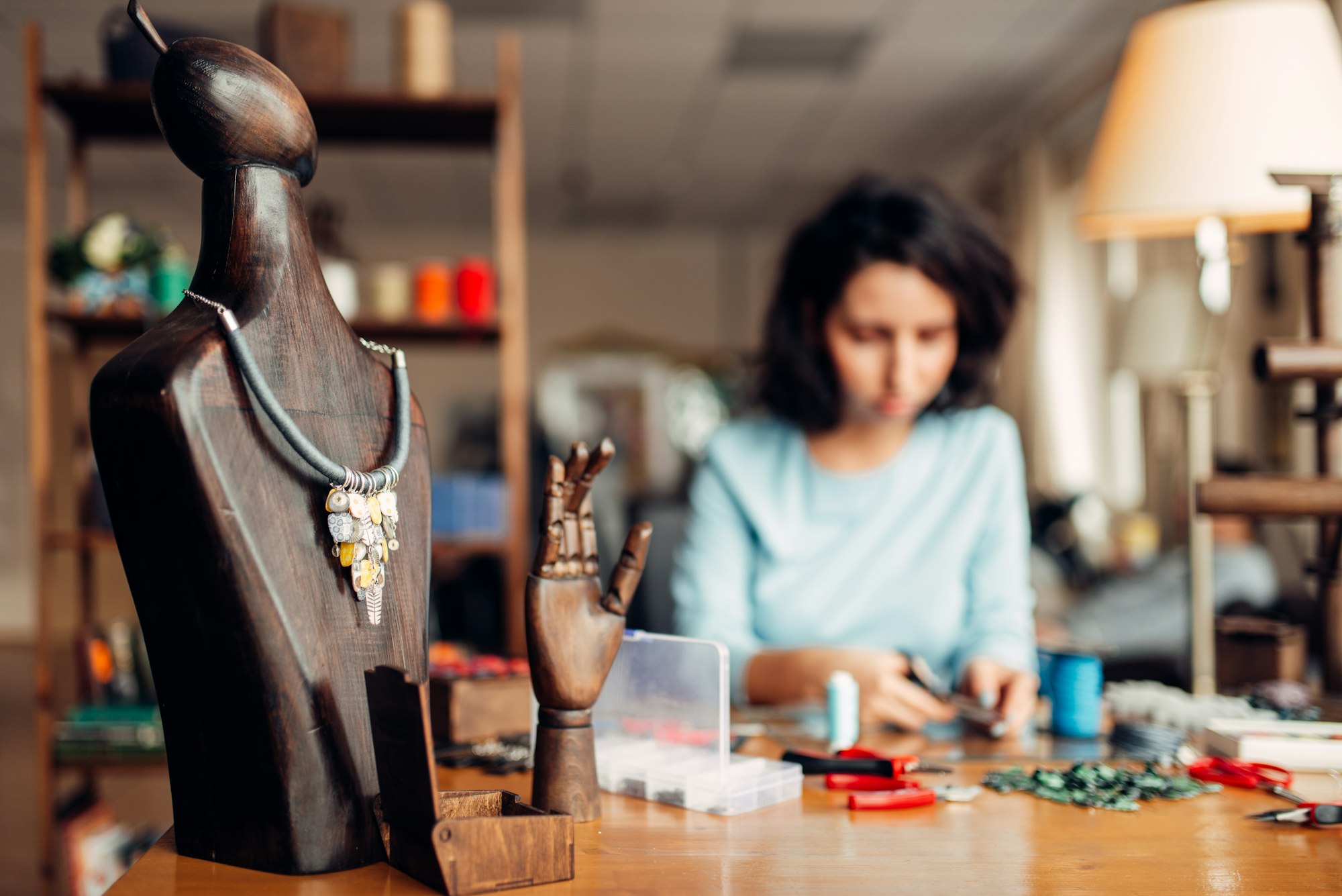 Handmade necklace on wooden mannequin, needlework